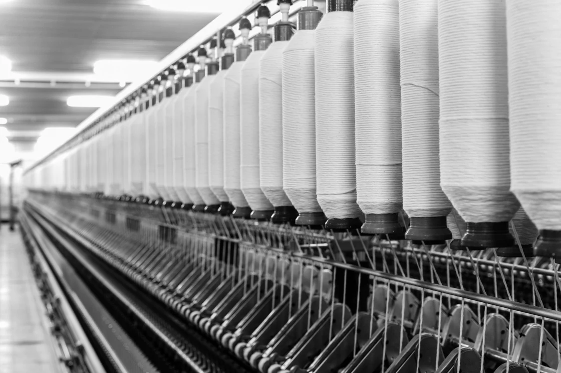 Textile yarn bobbins on spinning machinery